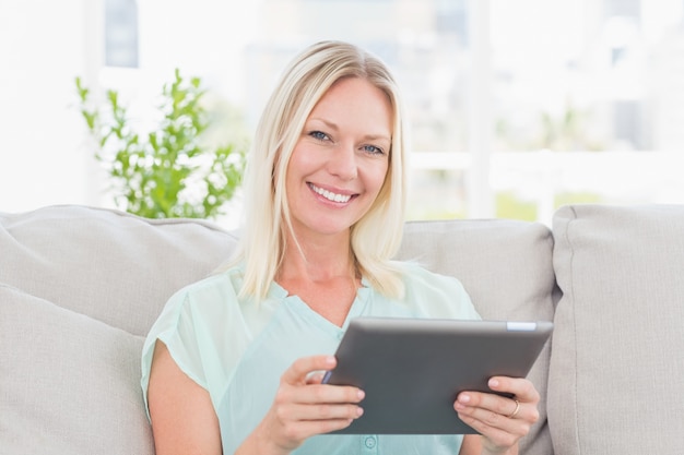 Happy woman using digital tablet