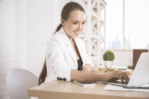 Happy woman using laptop