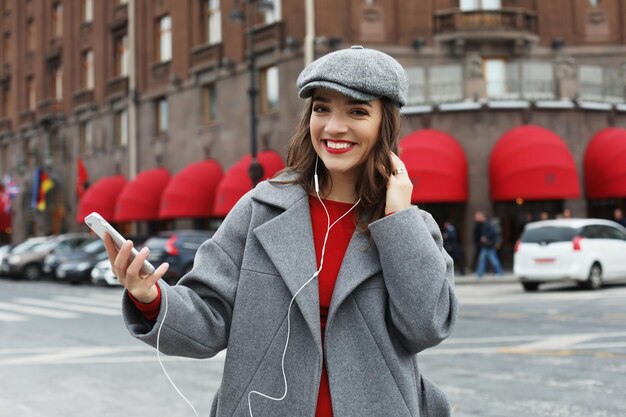 Happy woman walking in the city on a autumn day