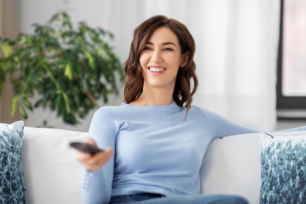 happy woman watching tv at home