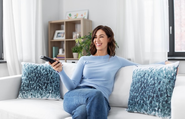 happy woman watching tv at home