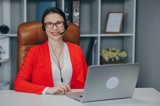 Happy woman wear headset at home office