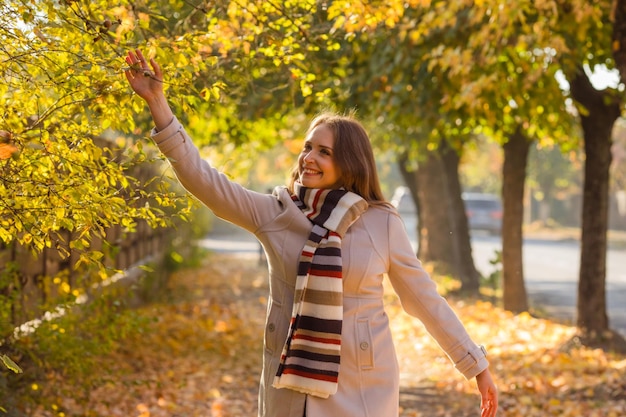 Happy woman wearing warm clothes in the park