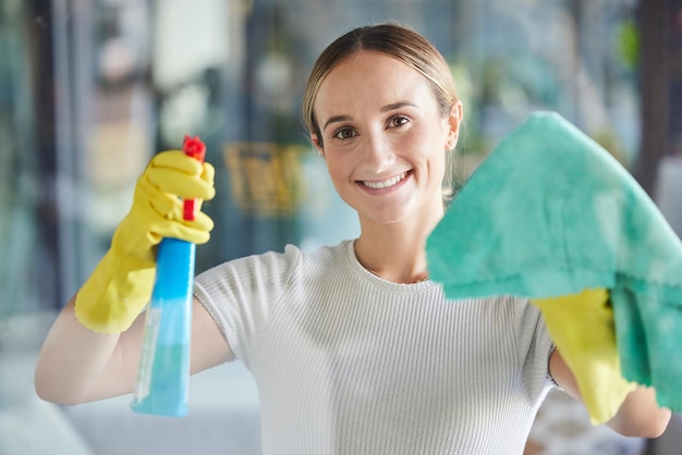 Happy woman window cleaning spray and bottle with cloth for dust bacteria or dirt in apartment home and Australia Portrait of maid housekeeping and cleaner wipe glass door or chemical detergent