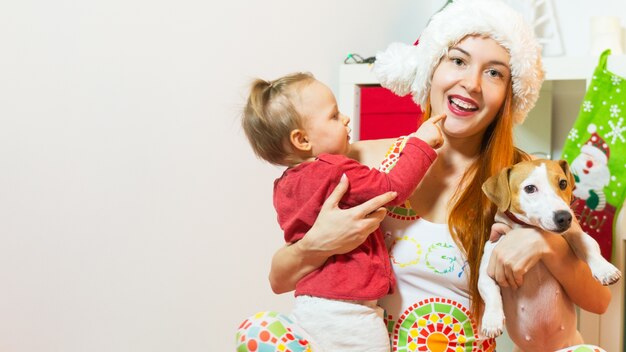 Happy woman with baby girl and dog