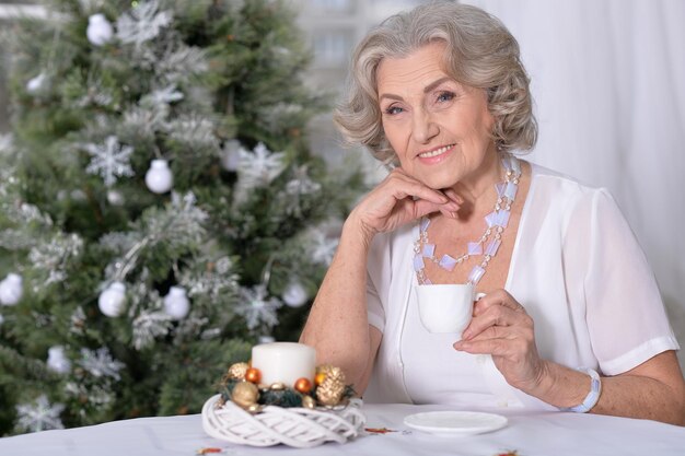 Happy woman  with cup of tea on Christmas