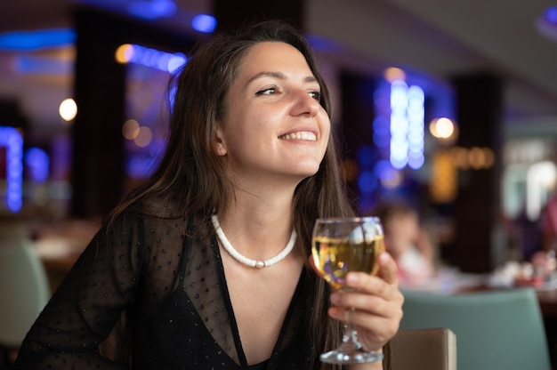 Happy woman with glass of white wine.