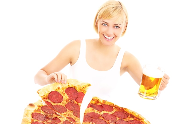 a happy woman with pizza and beer over white background