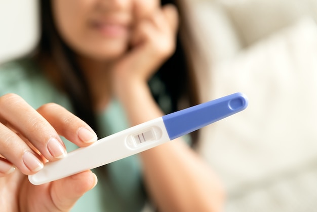 happy woman with pregnancy test positive result