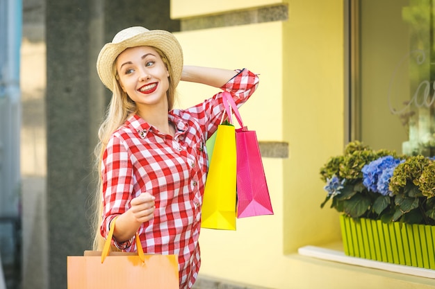  Happy woman with shopping bags enjoying in shopping. 