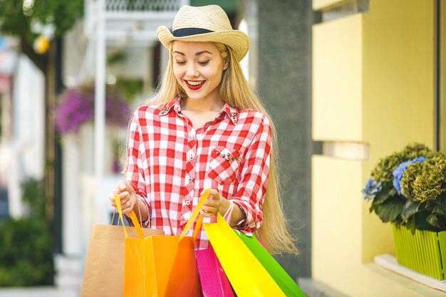  Happy woman with shopping bags enjoying in shopping. 