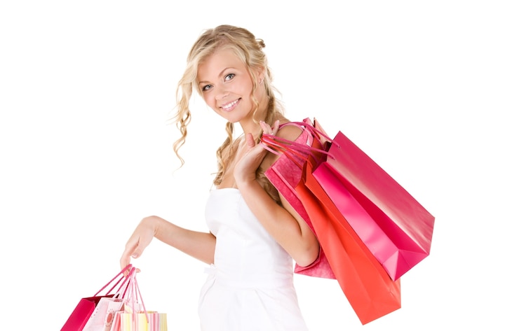 Photo happy woman with shopping bags over white wall