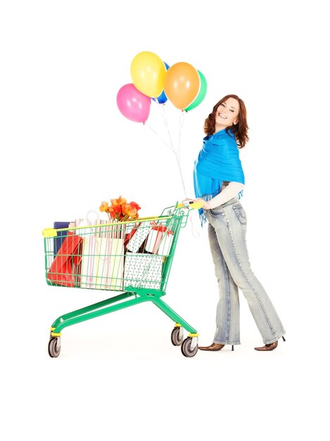 Photo happy woman with shopping cart and balloons over white