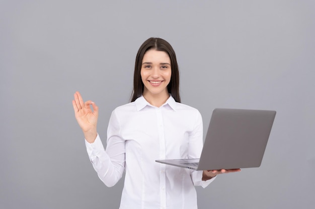 Happy woman working online modern wireless laptop programmer use pc businesswoman with laptop ok network administrator hold computer office manager in white shirt concept of agile business