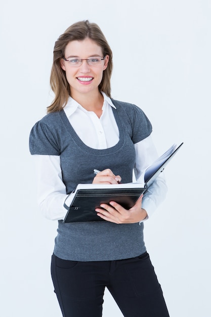 Happy woman writing in diary 