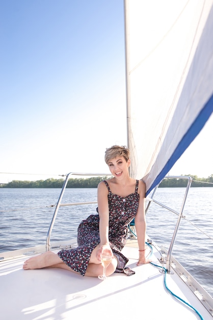 Happy woman on a yacht by the sea
