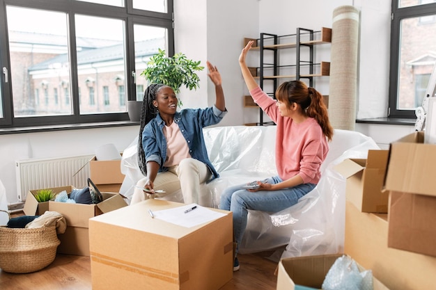 happy women moving to new home and counting money