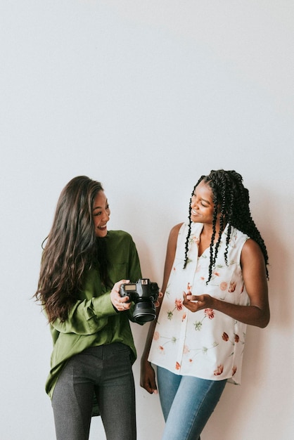 Happy women with a digital camera talking