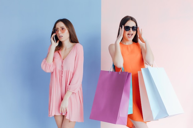 happy women with shopping bags