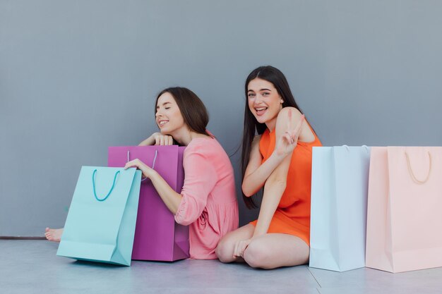 happy women with shopping bags