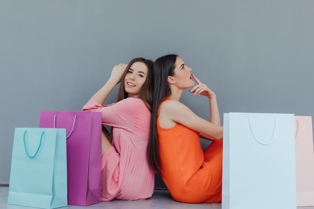 happy women with shopping bags