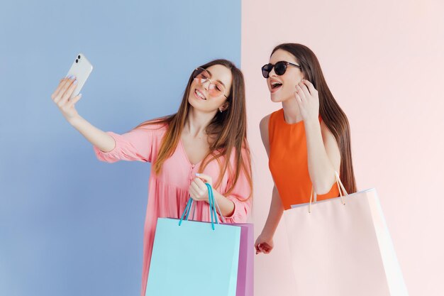 happy women with shopping bags