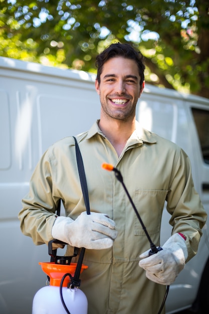 Happy worker with pesticide sprayer 