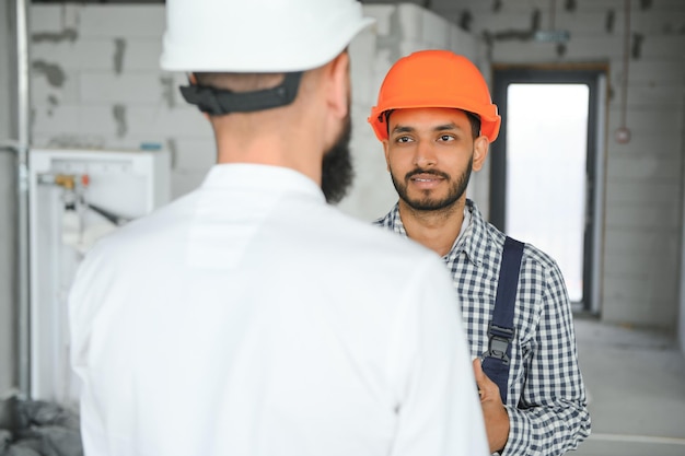 Happy workers at construction site young civil engineer manager and architects Indian and Arabian engineers