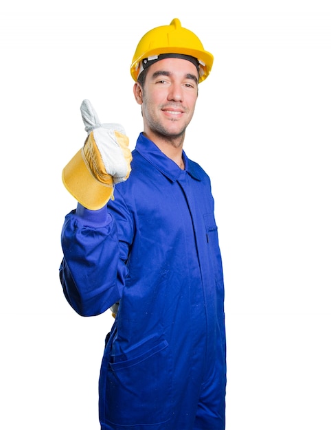 Happy workman with an okay gesture on white background