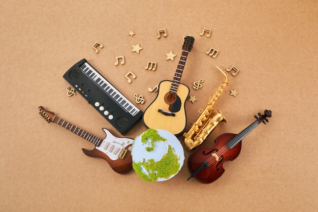 Музыкальные инструменты с мировым днем музыки на фоне земного шара