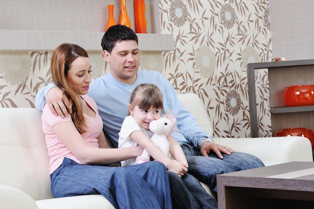 happy youg family relaxing in modern livingroom at home