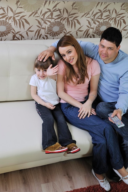 happy youg family relaxing in modern livingroom at home