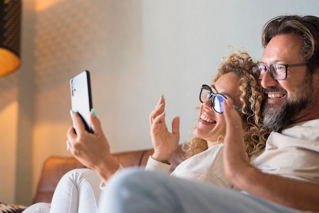 Happy Young Adult Couple Making Video Call On Phone