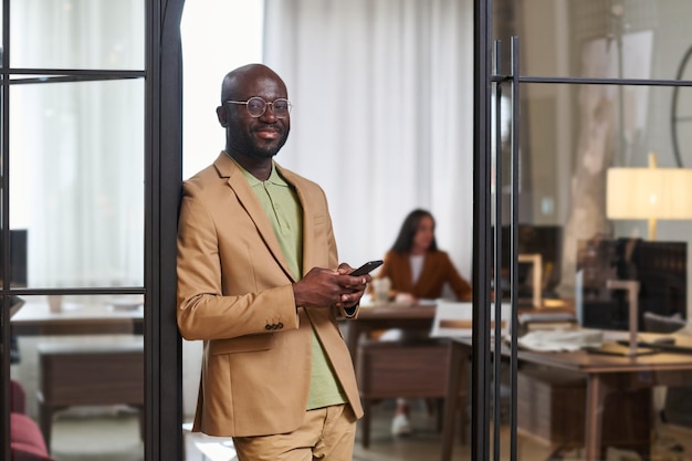 Happy young african american male designer in formalwear looking at camera