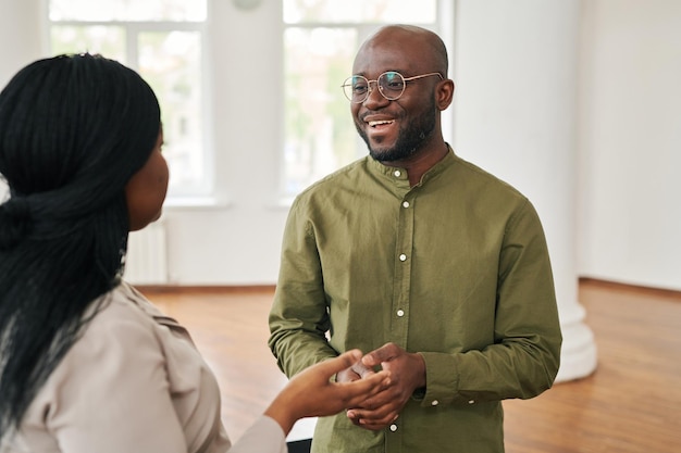 Happy young african american psychologist consulting female patient