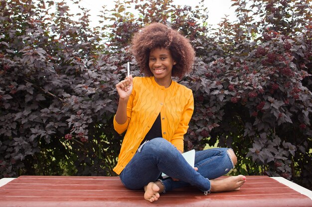 A Happy and young African American student in the park