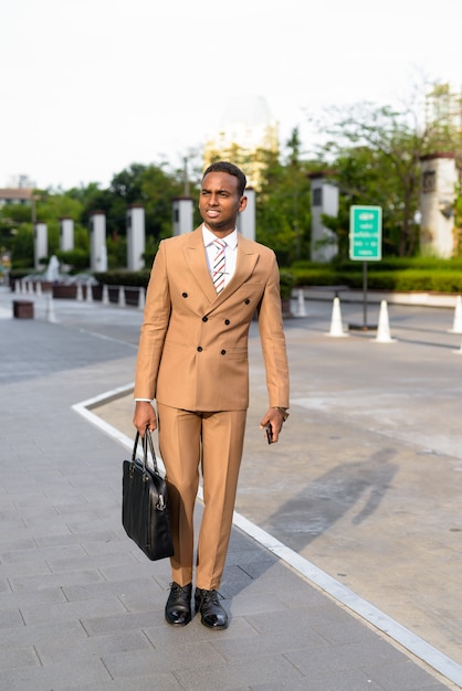 happy young African businessman thinking and ready for work