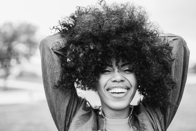 Happy young african woman smiling on camera outdoor Focus on mouth Black and white editing