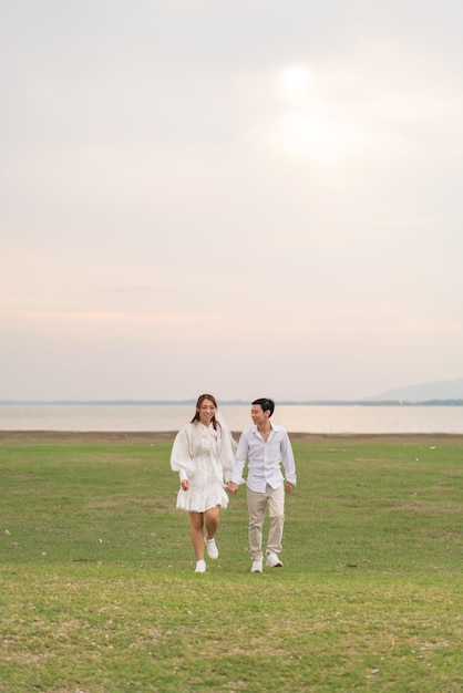 Happy young Asian couple in bride and groom clothing