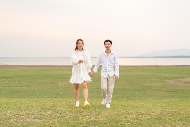 Happy young Asian couple in bride and groom clothing