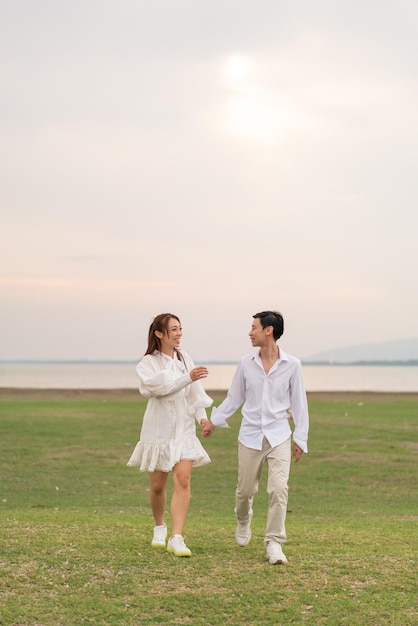 Happy young Asian couple in bride and groom clothing