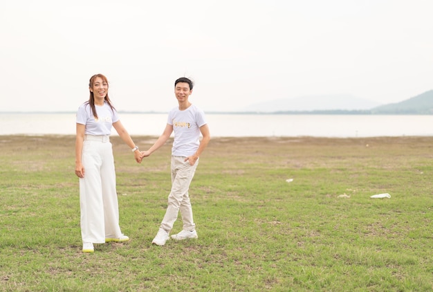 Happy young Asian couple in bride and groom tshirt