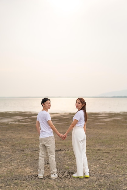 Happy young Asian couple in bride and groom tshirt