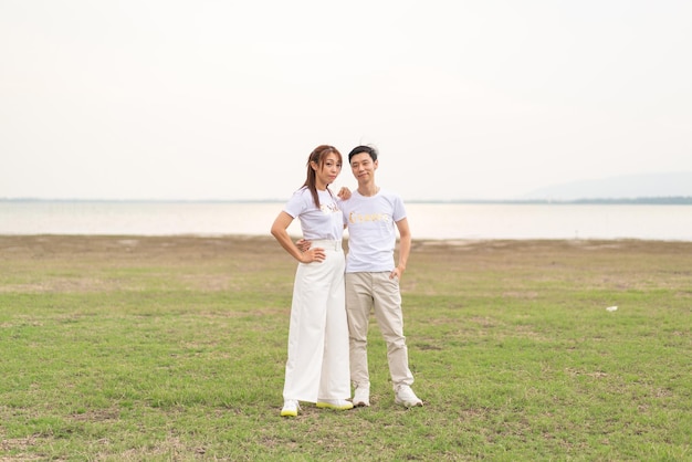 Happy young Asian couple in bride and groom tshirt