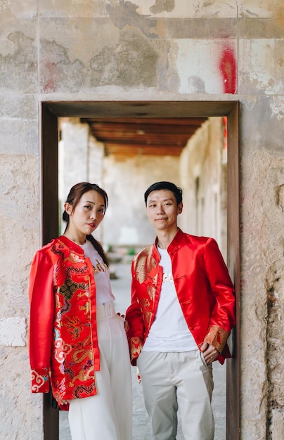 Happy young Asian couple in Chinese traditional dresses