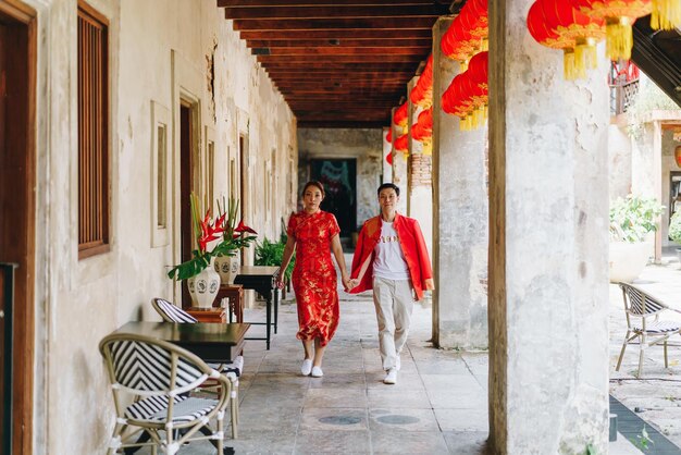 Happy young Asian couple in Chinese traditional dresses