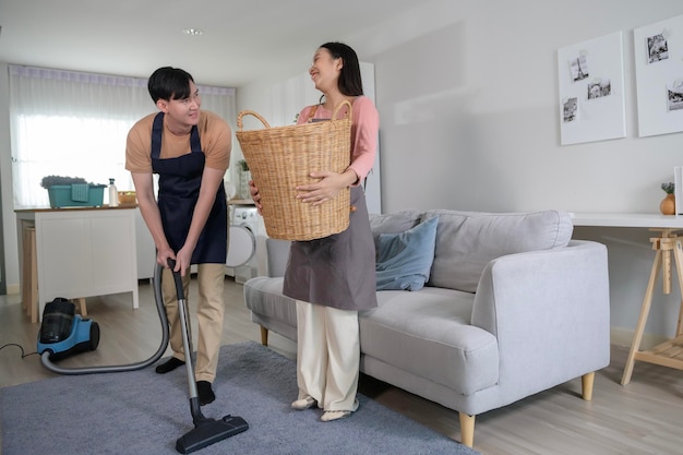 Happy young Asian couple cleaning home together healthy lifestyle concept