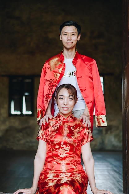 Happy young Asian couple love in Chinese traditional dresses - Red is the main color of the traditional festive that including wedding in China.