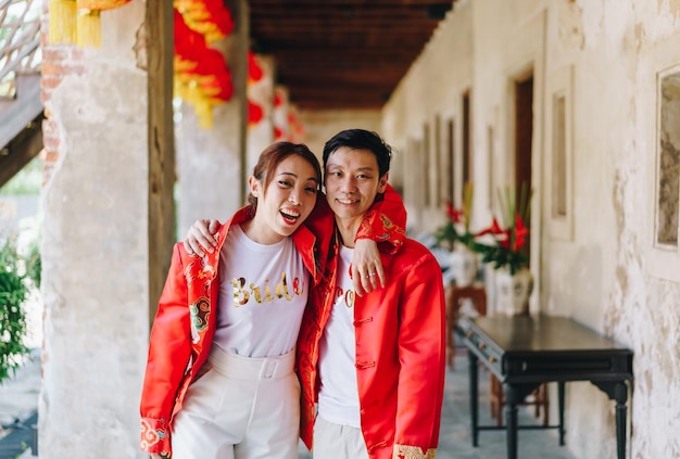 Happy young Asian couple love in Chinese traditional dresses - Red is the main color of the traditional festive that including wedding in China.