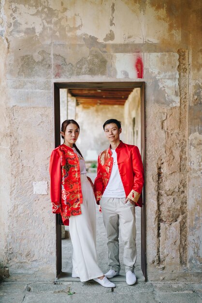 Happy young Asian couple love in Chinese traditional dresses - Red is the main color of the traditional festive that including wedding in China.